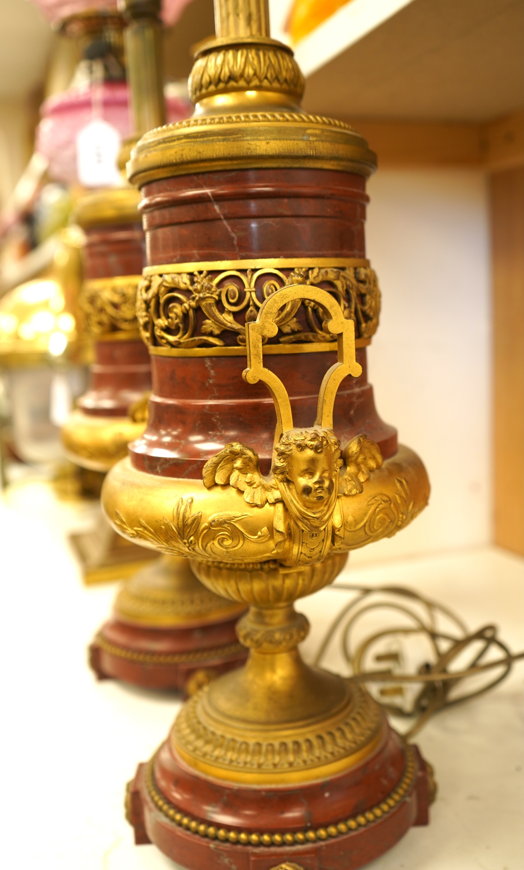 A pair of Empire style gilt metal and rouge marble table lamps, 50cm